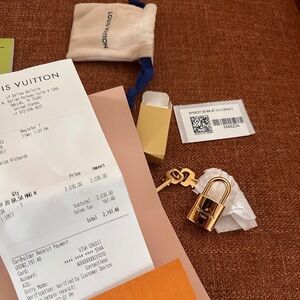 Louis Vuitton lock with key and dirt bag